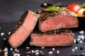 Close-up of steak Top Blade roasting medium ready to eat on dark stone background Royalty Free Stock Photo