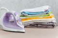 Close up steam iron colorful clothes washed laundry on white background. Housekeeping. Copy space advertisement. Place for text. Royalty Free Stock Photo