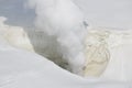 Close up of steam rising from a volcano in a winter snow landscape