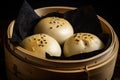 Close-up of steamed BBQ pork buns with sesame seeds on a bamboo basket