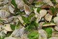 Close-up of steamed clams with garlic and parsley. Seafood background.