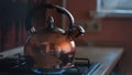 Close up of steaming tea kettle. Concept. Heater glowing under the steel polished kettle with boiling water and the Royalty Free Stock Photo