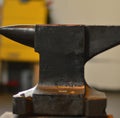 Close up of steel anvil lying on table in workshop