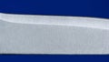 Knife blade close up, isolated on a blue background Royalty Free Stock Photo