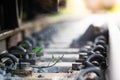 Close up Steel railroad fasteners.Iron nuts fastened to railway tracks.soft focus.Green morning glory in the train tracks Royalty Free Stock Photo