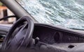 Close-up of the steering wheel of a car after an accident. The driver`s airbags did not deploy. Soft focus. Broken windshield wit