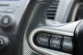 Close up steering wheel with control buttons close-up. Car stereo system control. Royalty Free Stock Photo