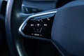 Close up of steering wheel of a new electric vehicle. Electric car control devices. Cruise control buttons, speed Royalty Free Stock Photo