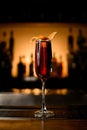 Close-up of stemware of red alcoholic drink on bar counter.