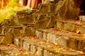 Close-up steps of stairs up from antique stone in autumn season. The symbol of upsurge and success. Recreation. Parks. Autumn