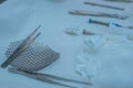 Close-up of a sterile operating table with medical neurosurgical instruments, including a titanium plate, a mesh for the skull,