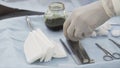 Close up of sterile surgical tools for the surgery. Action. Hand of a medical doctor in protective clean glove taking a Royalty Free Stock Photo