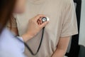 Close-up of stethoscope in hand Doctor checking heart rate listening to chest of young female patient with stethoscope in clinic Royalty Free Stock Photo