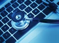 Close-up of stethoscope on laptop keyboard Royalty Free Stock Photo