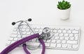 Close up of stethoscope on pc keyboard. Healthcare concept Royalty Free Stock Photo