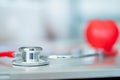 Close up stethoscope and red heart shape on medical table, medical concept Royalty Free Stock Photo