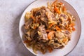 Close up of stewed oxtail with carrots and onions on a plate on the table top view