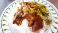 Close up stewed pork leg on white rice with pickled cabbage on white plate or dish at local street food, Thailand. Royalty Free Stock Photo