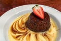 Close up of sticky toffee pudding topped with strawberry Royalty Free Stock Photo