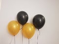 Close-up still image of decorative gold and black helium balloon