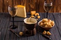 Close up. Still life. Traditional french cheese fondue. Crouton dipped into hot fondue cheese on a long-stemmed fork. Copy space Royalty Free Stock Photo