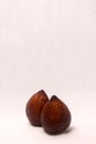 Close Up Still Life of Two Exotic Salak Palm Fruit with Brown Scaly Skin on White Background Royalty Free Stock Photo