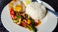 Close up Stir Fried Basil with squid and fried egg in Thai style on white plate or dish Royalty Free Stock Photo