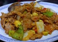 Close up stir fried pork Chili Paste with Onion, Cucumber and bell pepper in white blue pattern plate, Chinese food wok menu Royalty Free Stock Photo