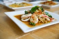 Close up of stir fried seafood with spicy fresh herbs on plate Royalty Free Stock Photo