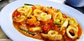 Close up Stir Fried Squid with Curry and Red salted egg on blue plate Royalty Free Stock Photo