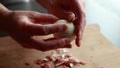 A close-up stock video featuring the hands of a woman delicately peeling a boiled egg,