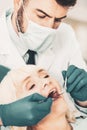 Close up of stomatologis checking teeth of elderly lady Royalty Free Stock Photo