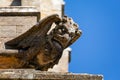 Close up of a stone gargoyle on the walls of Sherborne Abbey in Sherborne, Dorset, UK