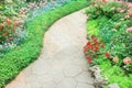 Stone pathways in nature garden with colorful ornamental flowers background