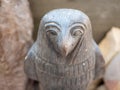 Close-up of a stone statuette of the Egyptian deity Horus with a bird`s head. Selective focus. Luxor, Egypt
