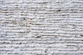 Close-up of stone surface with traces of processing. Parallel lines on the stone left by the cutting tool. Abstract Royalty Free Stock Photo