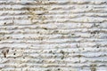 Close-up of stone surface with traces of processing. Parallel lines on the stone left by the cutting tool. Abstract Royalty Free Stock Photo