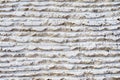 Close-up of stone surface with traces of processing. Parallel lines on the stone left by the cutting tool. Abstract Royalty Free Stock Photo
