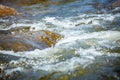 Close-up of stone with water rapids on the river Royalty Free Stock Photo