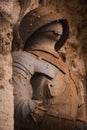 Close up of a stony old stone statue of a soldier with a military outfit Royalty Free Stock Photo