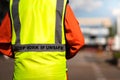 `Stop work if unsafe` on reflective vest for worker. Royalty Free Stock Photo