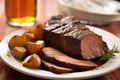 close-up of stout and slices of beef brisket on a white plate