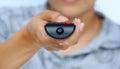 Close Up straight image of a female hand holding remote control, Focus at Infrared bulb of Remote Royalty Free Stock Photo