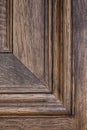 Close up straight on shot of a detail of paneling and wooden grain on a wooden door