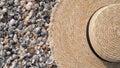 Close-up of a straw hat lies on the background of small sea shells on the beach,copy space.The concept of vacation,vacation,summer Royalty Free Stock Photo