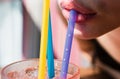 Close up straw in mouth. Summer juice cocktail drink. Straw in lips taste fresh cocktail.