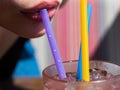 Close up straw in mouth. Summer juice cocktail drink. Straw in lips taste fresh cocktail. Sexy woman lips.