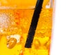 Close-up of straw in the yellow cocktail with ice cubes for background Royalty Free Stock Photo