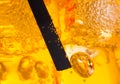 Close-up of straw in the yellow cocktail with ice cubes for background Royalty Free Stock Photo