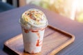 Close up Strawberry cheesecake frappuccino on wooden plate with copyspace in coffee shop